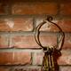 Bunch of antique keys on brick wall background... (thumbnail)