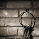 Bunch of antique keys on brick wall background black and white... (thumbnail)