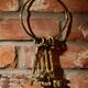 Bunch of antique keys hanging on brick wall... (thumbnail)
