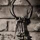 Bunch of antique keys hanging on brick wall black and white... (thumbnail)