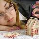 Young Woman Building a House from Matches... (thumbnail)
