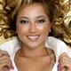 Beauty portrait of a smiling asian woman with golden hair... (thumbnail)