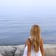 Woman Sitting on a Shore... (thumbnail)