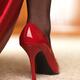 Woman in red high heels and black stockings closeup of a shoe... (thumbnail)