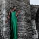 Woman in Long Dress Leaning Against a Stone Wall... (thumbnail)