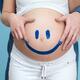 Couple Painting a Smiley on a Pregnant Woman's Belly... (thumbnail)