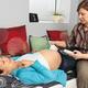 Midwife Monitoring a Pregnant Woman's Baby Heartbeat... (thumbnail)