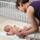 Mother Changing Diaper of a Baby... (thumbnail)