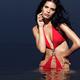 Beautiful Young Woman in Red Swimsuit Standing in Water... (thumbnail)