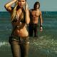 Young Woman and a Young Man Walking Out of Water... (thumbnail)