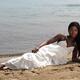 Young Woman In White Dress on the Beach... (thumbnail)