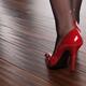 Woman in Red High Heels Walking on Hardwood Floor... (thumbnail)