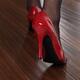 Woman in Red High Heels Walking on Hardwood Floor... (thumbnail)