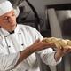Baker Holding Raw Bread... (thumbnail)