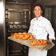 Baker with a Freshly Baked Breads on a Tray... (thumbnail)