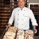 Baker with a Freshly Baked Breads on a Tray... (thumbnail)