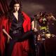 Beautiful Woman in Red Coat at a Festive Table... (thumbnail)