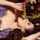 Beautiful Woman Eating Grapes on a Festive Table... (thumbnail)