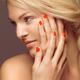 Beautiful Young Woman with Orange Nail Polish... (thumbnail)