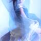 Woman dancing surrounded with blue shiny light... (thumbnail)
