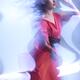 Fashion Photo of a Woman in Shining Blue Light Wearing a Red Dress... (thumbnail)