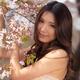 Portrait of a Young Smiling Woman Standing at a Cherry Tree... (thumbnail)