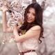 Portrait of a Young Smiling Woman Standing at a Cherry Tree... (thumbnail)