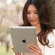 Young Woman Outdoors with iPad in Park... (thumbnail)