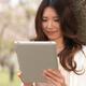 Young Woman Outdoors with a Tablet Computer... (thumbnail)