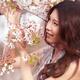 Portrait of a Young Smiling Woman Standing at a Cherry Tree... (thumbnail)