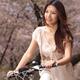Young Smiling Woman Riding a Bike in a Park... (thumbnail)