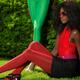Young Woman in Fancy Bright Clothes Sitting on the Grass... (thumbnail)