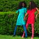 Two Women Wearing Bright Dresses in a Park... (thumbnail)