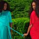 Two Women Wearing Bright Dresses in a Park... (thumbnail)
