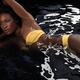 Woman Wearing Bikini Lying in Water... (thumbnail)