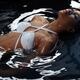 Beautiful Woman in Swimsuit Lying in Water... (thumbnail)