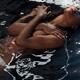 Beautiful black african-american woman lying in water half-naked Sensu... (thumbnail)