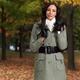 Woman in a City Park Wearing a Green Coat... (thumbnail)