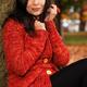 Smiling Woman Cuddling in a Sweater in the Wind... (thumbnail)