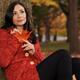 Young Smiling Woman Cuddling in a Sweater in Autumn... (thumbnail)