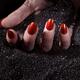 Woman Hand With Red Nails on Black Sand... (thumbnail)