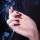 Woman Hand in a Stream of Smoke... (thumbnail)