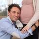 Man listening to baby moving inside woman's belly... (thumbnail)