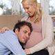Husband listening to baby moving inside his wife's belly... (thumbnail)