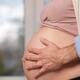 Man's hands on pregnant woman's belly... (thumbnail)