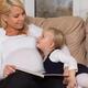 Mother and her little daughter reading a book together... (thumbnail)