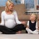 Pregnant mother and little daughter doing yoga... (thumbnail)