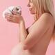 Pregant young woman holding a bunny in her hands... (thumbnail)
