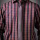Man wearing a dark tartan shirt with a skinny necktie... (thumbnail)