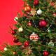 Decorated Christmas tree on red background... (thumbnail)